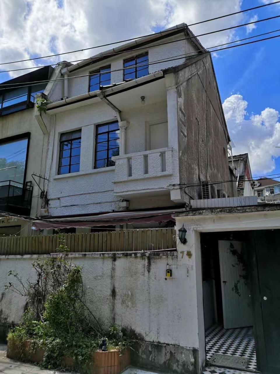 Old lane house with small yard and roof terrace on the quiet Xingguo Road for sale.